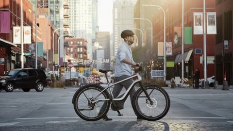 a man riding a bicycle on a city street